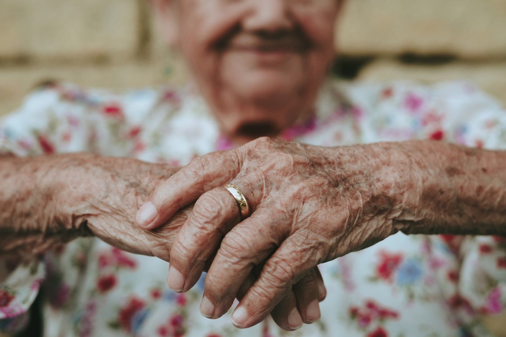 Hands of a senior man wearing a wedding band.